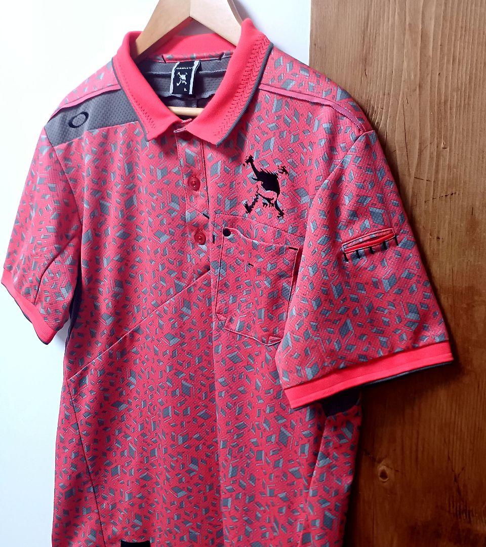 オークリーゴルフ　メンズ　半袖ポロシャツ　オレンジ系　サイズL　スカル　総柄