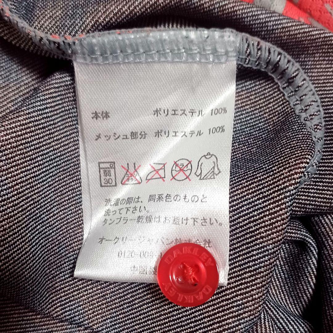 オークリーゴルフ　メンズ　半袖ポロシャツ　オレンジ系　サイズL　スカル　総柄