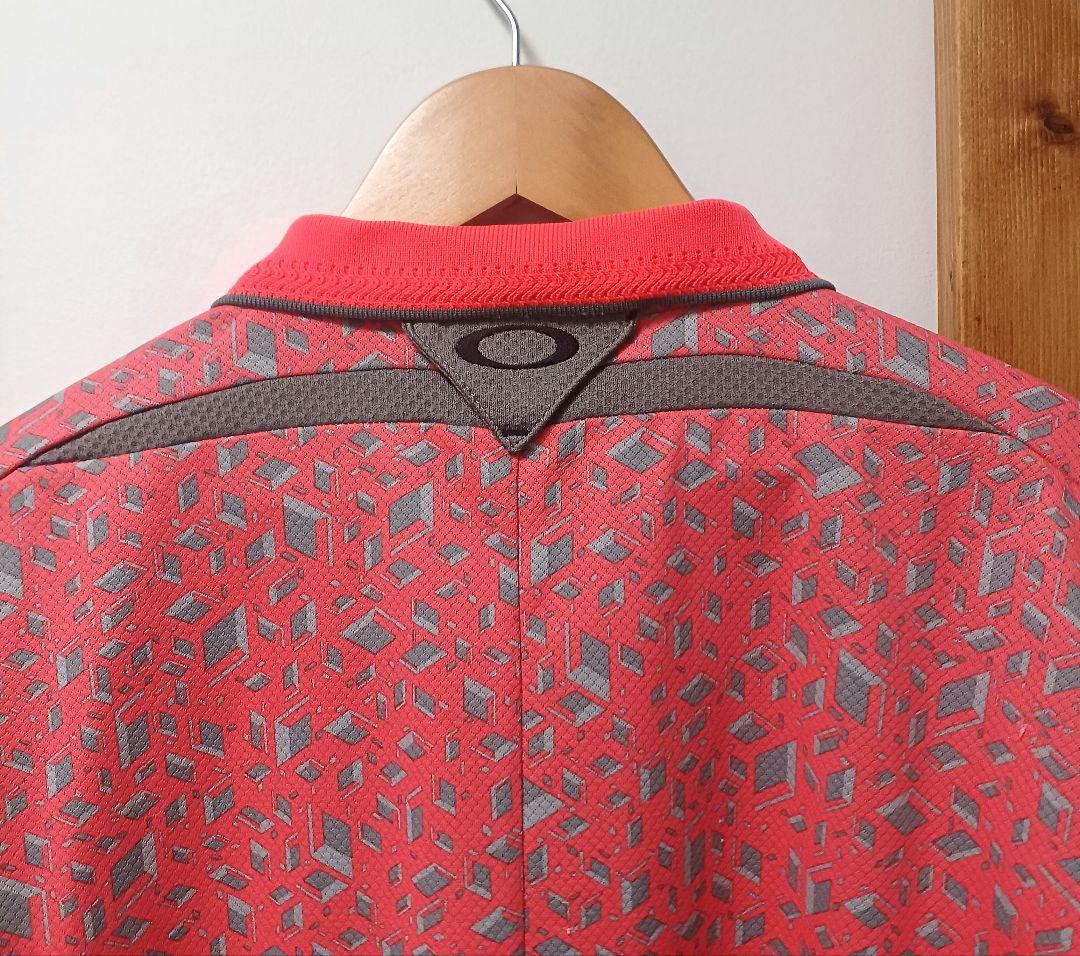 オークリーゴルフ　メンズ　半袖ポロシャツ　オレンジ系　サイズL　スカル　総柄